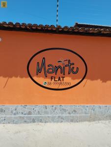 a sign on the side of a restaurant at Manitu Flat Canoa Quebrada in Canoa Quebrada