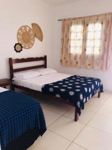 sypialnia z 2 łóżkami i oknem w obiekcie Manitu Flat Canoa Quebrada w mieście Canoa Quebrada