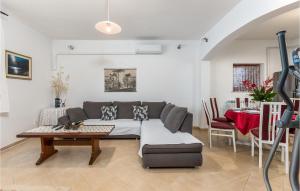 a living room with a couch and a table at 2 Bedroom Gorgeous Apartment In Kostrena in Kostrena