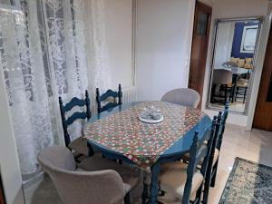 a dining room table and chairs with a patterned table at Kalian Meteora in Kalabaka