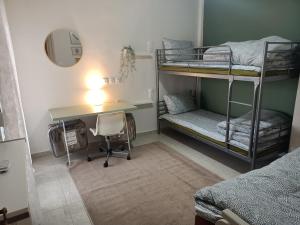 a room with two bunk beds and a desk at Kalian Meteora in Kalabaka +20 photos