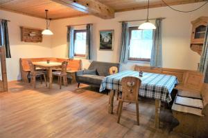 a living room with a table and a couch at Ahornhütte in Schladming