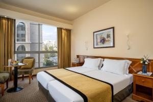Ένα ή περισσότερα κρεβάτια σε δωμάτιο στο Olive Tree Hotel