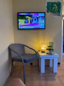 A television and/or entertainment centre at Relax and enjoy with a view of El Teide and sea