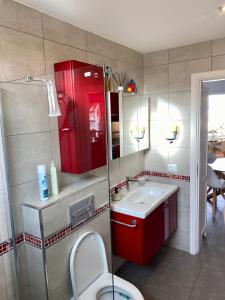 een badkamer met een rode kast en een wastafel bij Relax and enjoy with a view of El Teide and sea in Puerto de Santiago