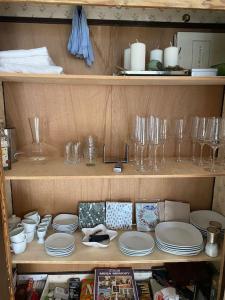 a wooden shelf with dishes and glasses on it at Die HarzSchrittMacher - Bergmann 24 in Bad Harzburg