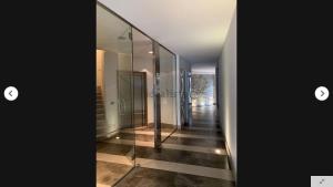 a hallway with glass walls and ailed floor at Il Borgo in Trieste