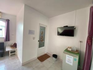 a white room with a television on a wall at Winnerview Zone B in Ko Larn