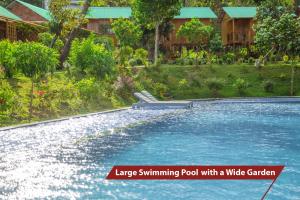 a swimming pool with a water garden and a house at Sim Bungalow in Phu Quoc