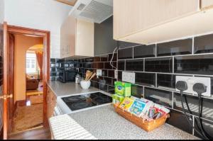 a kitchen with black tiles on the wall at Georges57 2-Bed Apartment in Inverness in Inverness