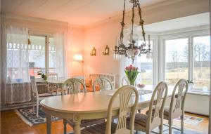 a dining room with a table and chairs at Awesome Home In Karlskrona With Wifi And 3 Bedrooms in Karlskrona