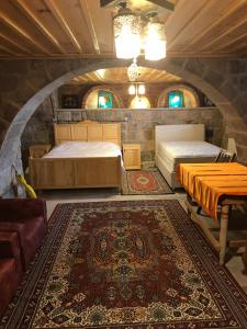 a room with two beds and a rug at Eshel Mansion Near Cappadocia And Erciyes in Talas