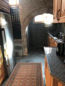 a kitchen with a counter and an archway in a room at Eshel Mansion Near Cappadocia And Erciyes in Talas