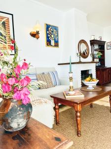 a living room with a vase of flowers on a table at Casa Yaya Nerja in Nerja