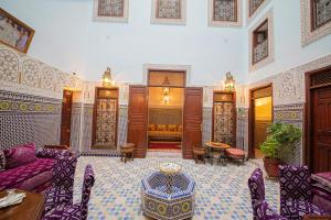 a living room with a couch and a table at Riad Baba in Fès