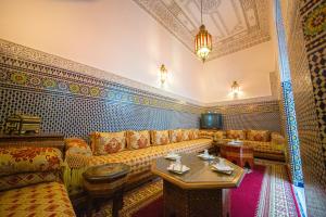 a living room with a couch and a table at Riad Baba in Fez