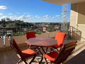 a table and chairs on a balcony with a view at Aurelia Sweet House in Rome