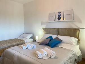a bedroom with two beds with towels on the bed at Aurelia Sweet House in Rome