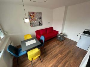 a living room with a red couch and a table at FOUR PEARLS in Karlovac