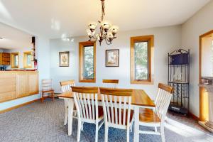a kitchen and dining room with a wooden table and chairs at Broadlake in Thayer Beach