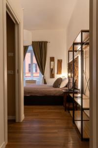 En eller flere senge i et værelse på Alessandria Suites Roma