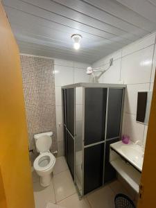 a bathroom with a toilet and a sink at Casa na Orla - Praia de Gaibu! in Cabo de Santo Agostinho