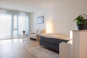 a living room with a bed and a couch at Senevita Dorfmatt Ferienwohnungen und Apartments in Münsingen