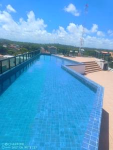 a large swimming pool on the roof of a building at Flat- maraca bech residence 2 in Ipojuca