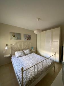 a bedroom with a bed with a white bed frame at Los Menceyes Yaral in Candelaria