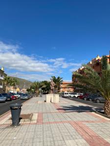 a sidewalk in a city with cars parked at Los Menceyes Yaral in Candelaria