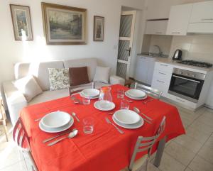 a dining room table with a red table cloth at La dimora degli Angeli in Moggio