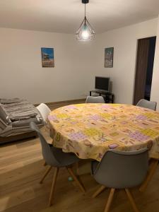 a room with a table with chairs and a bed at Spacieux F3 Port Leucate in Leucate