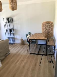 a living room with a table and a chair at APPARTEMENT REFAIT A NEUF, IDEALEMENT SITUÉ in La Baule