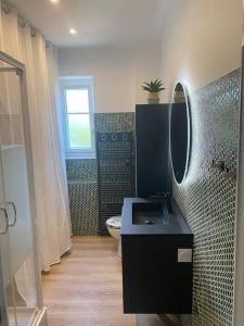 a bathroom with a toilet and a sink and a mirror at APPARTEMENT REFAIT A NEUF, IDEALEMENT SITUÉ in La Baule
