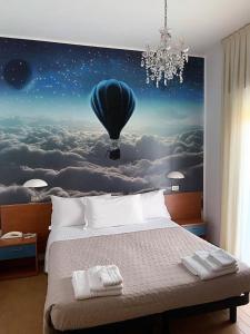 a bedroom with a large bed with a blue balloon at Hotel President in Cervia