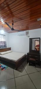 a bedroom with a bed and a ceiling fan at Villa DEE DEE in Galle