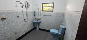 a bathroom with a blue toilet and a shower at Villa DEE DEE in Galle