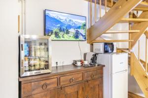 a kitchen with a refrigerator and a microwave at Ferienhaus Alte Mühle Hohentauern in Hohentauern