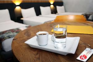 a glass of water and a cup of coffee on a table at Istanbul Fair Hotel in Istanbul