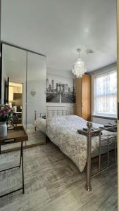 a bedroom with a bed and a table and a chandelier at Palaz 5 - 3 bedroom Apartment in Edmonton