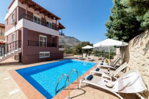 a villa with a swimming pool and a house at Villa Kermes Heated Pool in Kournás