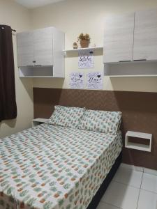 a bedroom with a bed with a comforter on it at Dunas Residence casa 04- Lençois Maranhense in Santo Amaro