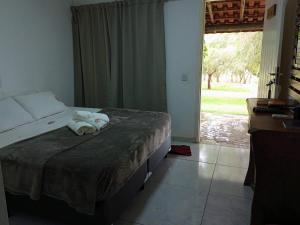 a bedroom with a bed with towels on it at POUSADA SAKURA in Patrimônio São Sebastião