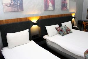 a hotel room with two beds and two pillows at Istanbul Fair Hotel in Istanbul