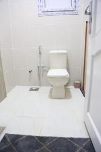 ein weißes Bad mit einem WC und einem Fenster in der Unterkunft دريم لاند السادس من أكتوبر in Kairo