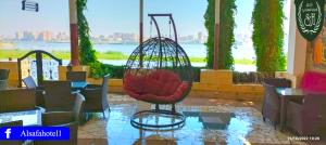a swing in a restaurant with a view of the water at فندق الصفا السياحي سوهاج in Sūhāj