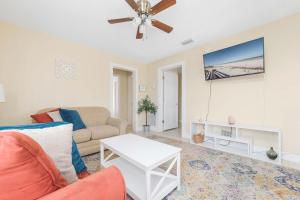 a living room with a couch and a ceiling fan at Cordova Dream Upper in Saint Augustine