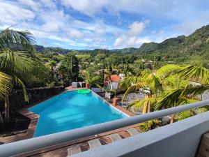 a view from the balcony of a villa with a swimming pool at Vista Do Vale in Furnas