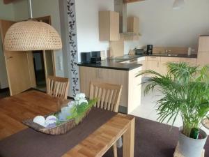 a kitchen with a table and a dining room at FeWo La Casa - Ferien im Münsterland in Ahaus