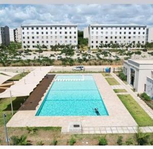 an overhead view of a swimming pool with two buildings at Kiki's @ Palm Ridge-Vipingo in Kilifi